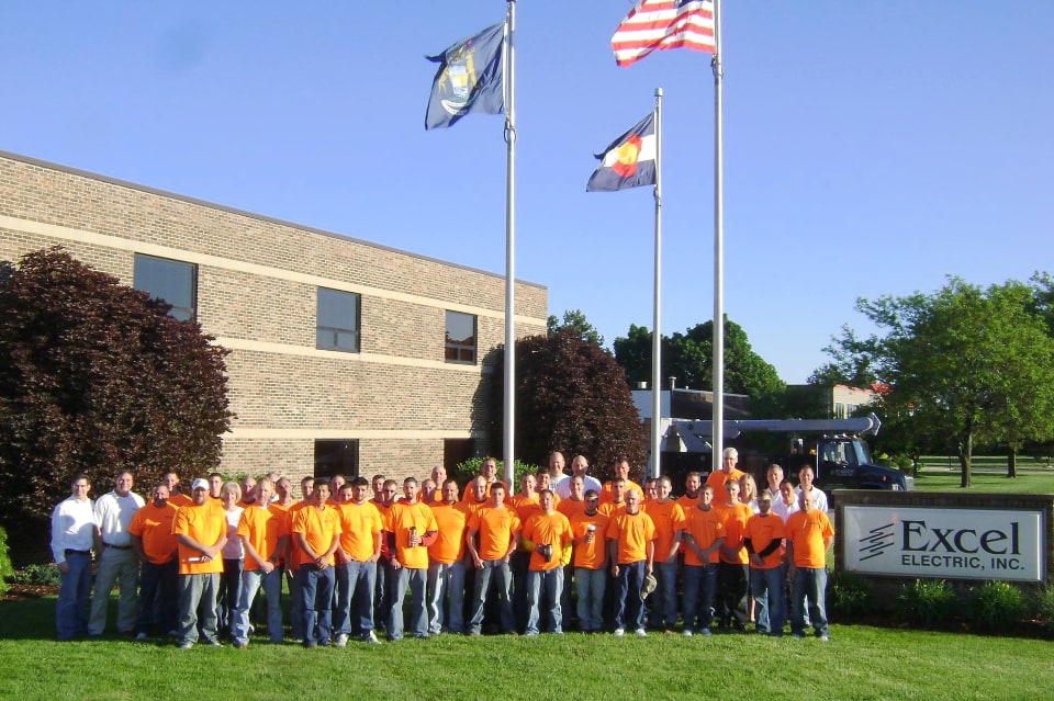 a photo of the staff of Excel Elctric standing outside their Grandville office